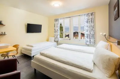 Ein Bett oder Betten in einem Zimmer der Unterkunft Alpenrose Hotel and Gardens