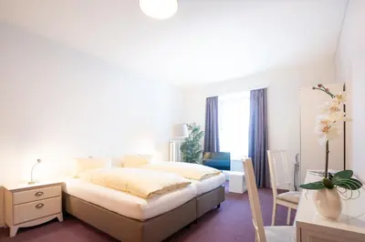 Ein Bett oder Betten in einem Zimmer der Unterkunft Hotel Landhaus Adler