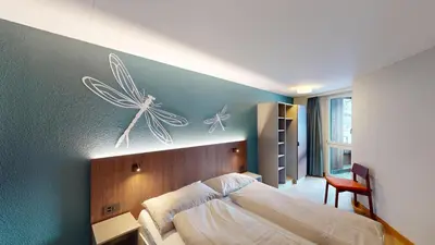 Ein Bett oder Betten in einem Zimmer der Unterkunft Reka-Feriendorf Sörenberg