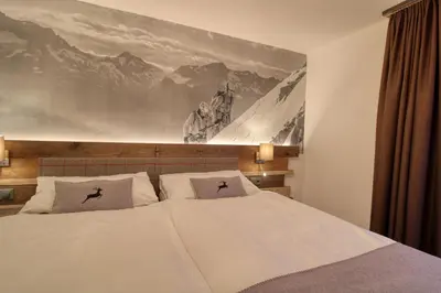 Ein Bett oder Betten in einem Zimmer der Unterkunft Matterhorngruss Apartments