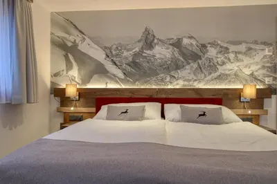 Ein Bett oder Betten in einem Zimmer der Unterkunft Matterhorngruss Apartments