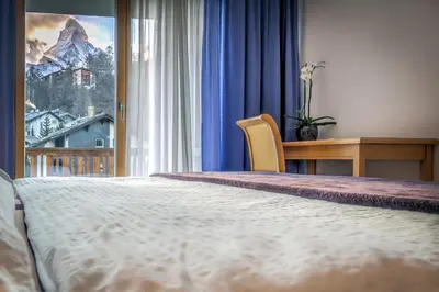 Ein Bett oder Betten in einem Zimmer der Unterkunft Matterhorngruss Apartments