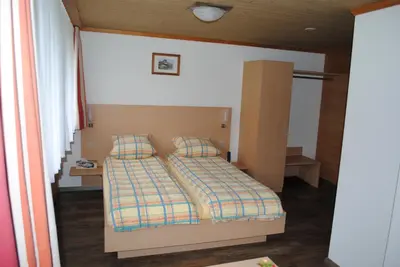 Ein Bett oder Betten in einem Zimmer der Unterkunft Hotel Des Alpes