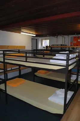 Ein Bett oder Betten in einem Zimmer der Unterkunft Hotel Des Alpes