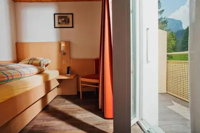 Ein Bett oder Betten in einem Zimmer der Unterkunft Hotel Des Alpes
