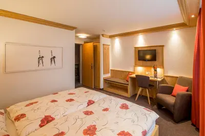 Ein Bett oder Betten in einem Zimmer der Unterkunft Hotel Alpbach