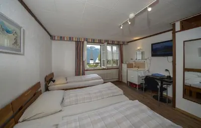 Ein Bett oder Betten in einem Zimmer der Unterkunft Swiss Lodge Hotel Bernerhof
