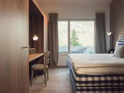 Ein Bett oder Betten in einem Zimmer der Unterkunft OVERLOOK Lodge by CERVO Zermatt