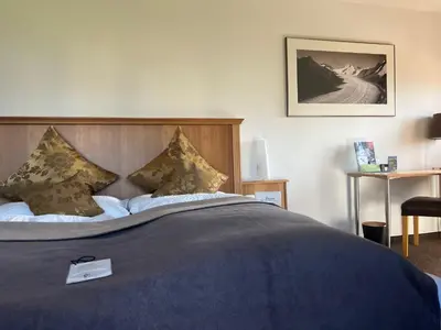 Ein Bett oder Betten in einem Zimmer der Unterkunft Hotel Alpina