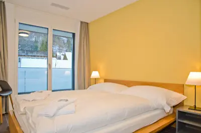 Ein Bett oder Betten in einem Zimmer der Unterkunft Apartment Gänseblüemli - GRIWA RENT AG