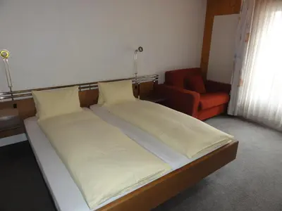 Ein Bett oder Betten in einem Zimmer der Unterkunft Hotel Steinbock Grindelwald