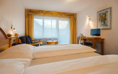 Ein Bett oder Betten in einem Zimmer der Unterkunft Walliserhof