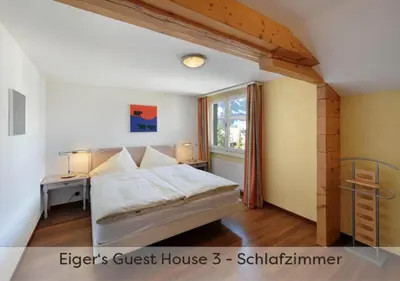 Ein Bett oder Betten in einem Zimmer der Unterkunft Eiger Guest House - Grindelwald