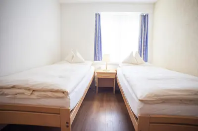 Ein Bett oder Betten in einem Zimmer der Unterkunft Eiger Guest House - Grindelwald