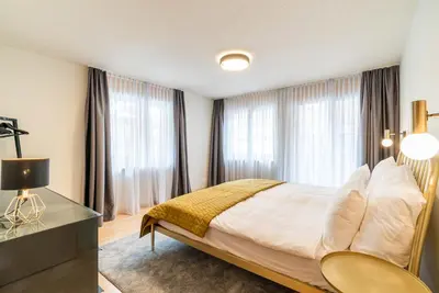 Ein Bett oder Betten in einem Zimmer der Unterkunft Vrony Apartments by Hotel Walliserhof Zermatt