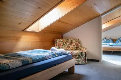 Ein Bett oder Betten in einem Zimmer der Unterkunft Hotel Gletscherblick Grindelwald