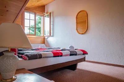 Ein Bett oder Betten in einem Zimmer der Unterkunft Hotel Gletscherblick Grindelwald