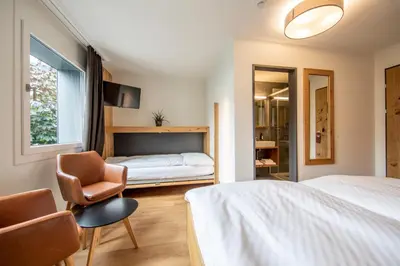 Ein Bett oder Betten in einem Zimmer der Unterkunft Hotel Meiringen
