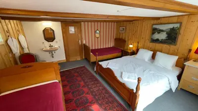 Ein Bett oder Betten in einem Zimmer der Unterkunft Pension Gimmelwald