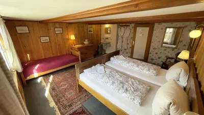Ein Bett oder Betten in einem Zimmer der Unterkunft Pension Gimmelwald