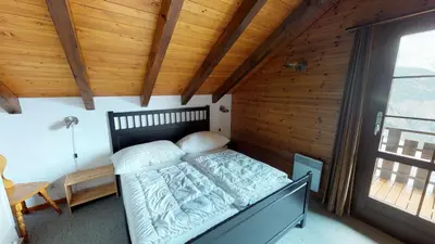 Ein Bett oder Betten in einem Zimmer der Unterkunft Tschuggen 61
