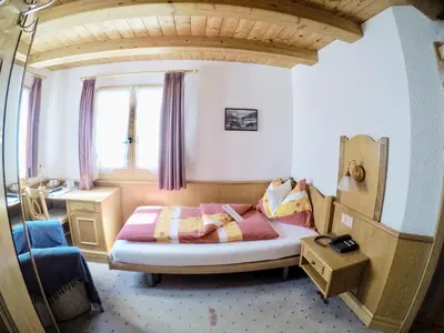 Ein Bett oder Betten in einem Zimmer der Unterkunft Alpina