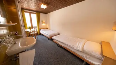 Ein Bett oder Betten in einem Zimmer der Unterkunft Sportchalet Mürren