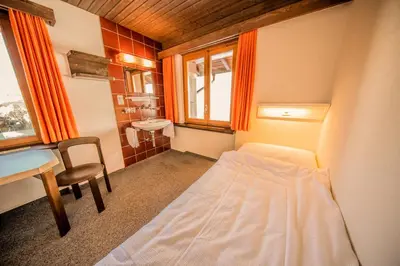 Ein Bett oder Betten in einem Zimmer der Unterkunft Sportchalet Mürren