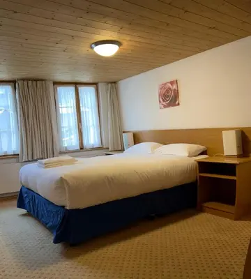 Ein Bett oder Betten in einem Zimmer der Unterkunft Chalet Rosa B&B