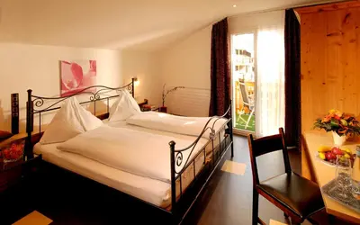 Ein Bett oder Betten in einem Zimmer der Unterkunft Park-Hotel Saas- Fee