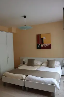 Ein Bett oder Betten in einem Zimmer der Unterkunft Hôtel Elite