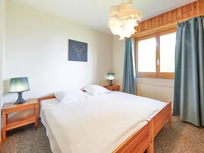 Ein Bett oder Betten in einem Zimmer der Unterkunft Apartment Hameau D004 by Interhome