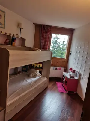 Ein Bett oder Betten in einem Zimmer der Unterkunft Anzère skis - promenade
