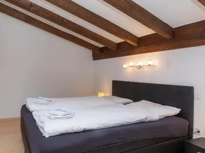 Ein Bett oder Betten in einem Zimmer der Unterkunft Chalet Maison Le Fontany by Interhome
