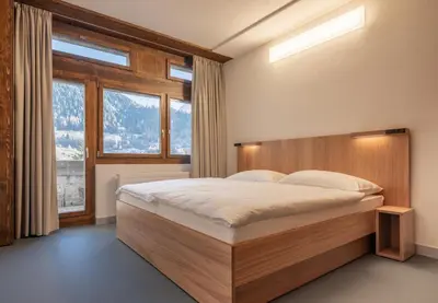 Ein Bett oder Betten in einem Zimmer der Unterkunft Sport Resort Fiesch, Garni Goneri