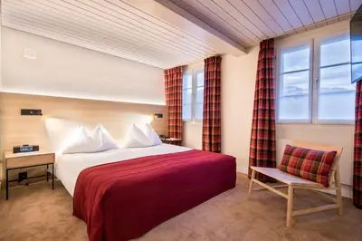 Ein Bett oder Betten in einem Zimmer der Unterkunft Hotel Kreuz & Post Grindelwald