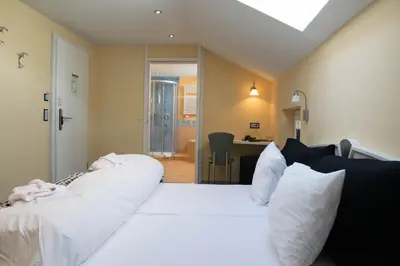 Ein Bett oder Betten in einem Zimmer der Unterkunft Hotel Europa