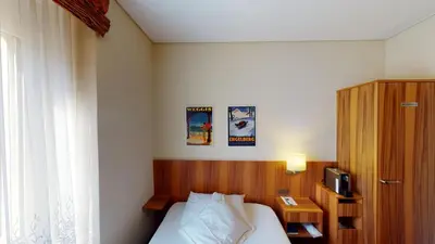 Ein Bett oder Betten in einem Zimmer der Unterkunft Hotel Ambassador