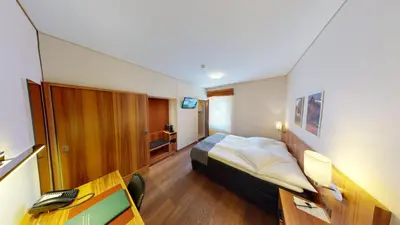 Ein Bett oder Betten in einem Zimmer der Unterkunft Hotel Ambassador