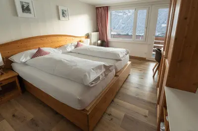 Ein Bett oder Betten in einem Zimmer der Unterkunft Hotel Bernerhof Grindelwald