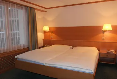Ein Bett oder Betten in einem Zimmer der Unterkunft Hotel Metropol & Spa Zermatt