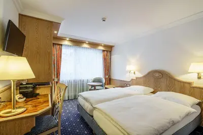 Ein Bett oder Betten in einem Zimmer der Unterkunft Hotel Alpenroyal