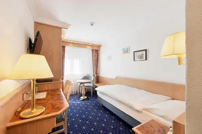 Ein Bett oder Betten in einem Zimmer der Unterkunft Hotel Alpenroyal