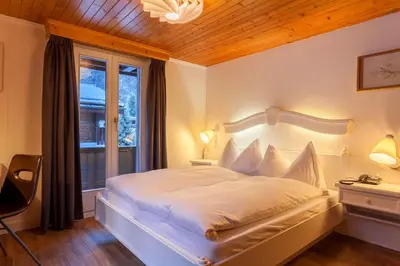 Ein Bett oder Betten in einem Zimmer der Unterkunft Hotel THE LARIX ski-in ski-out