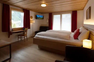 Ein Bett oder Betten in einem Zimmer der Unterkunft Hotel Hirschen - Grindelwald