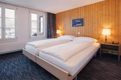 Ein Bett oder Betten in einem Zimmer der Unterkunft Jungfrau Lodge, Swiss Mountain Hotel