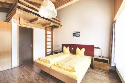 Ein Bett oder Betten in einem Zimmer der Unterkunft Hotel Alpina