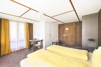 Ein Bett oder Betten in einem Zimmer der Unterkunft Hotel Alpina