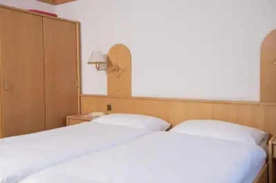 Ein Bett oder Betten in einem Zimmer der Unterkunft Hotel Monte-Moro