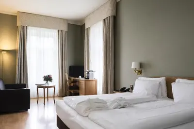 Ein Bett oder Betten in einem Zimmer der Unterkunft Grand Hotel Beau Rivage Interlaken